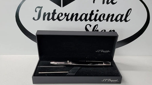 S.T. Dupont Defi multifunction pen sitting in display box with ink and lead refills.