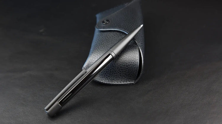 S.T. Dupont Black Defi luxury ballpoint pen on a luxury black grained leather pen case