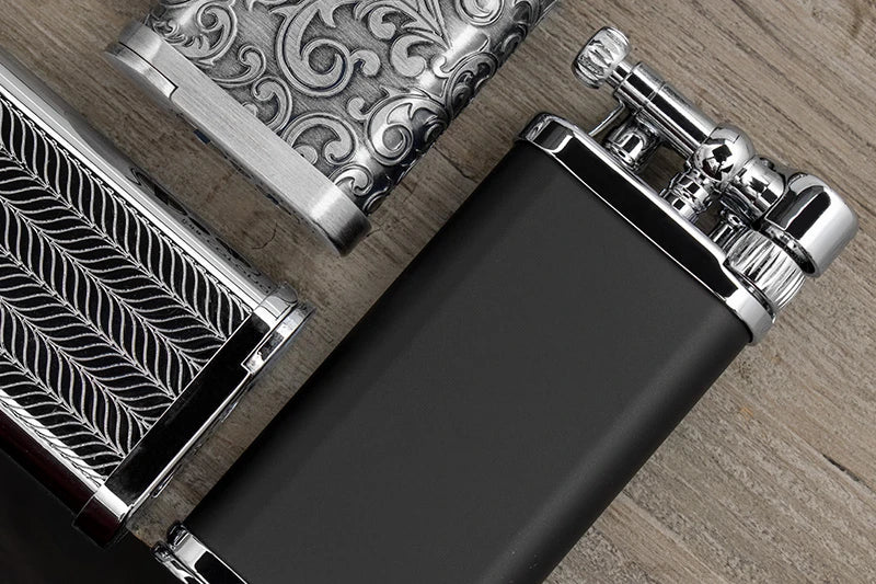 IM Corona Old Boy pipe lighter in matte black with chrome accents, silver herringbone and silver arabesque patterns.