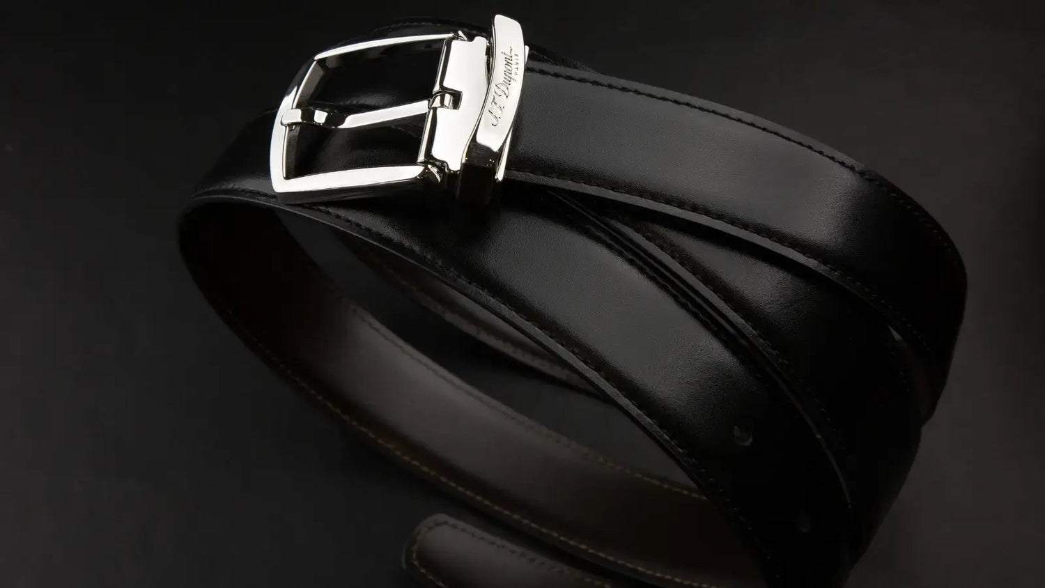 S.T. Dupont black leather dress belt wrapped up with palladium buckle