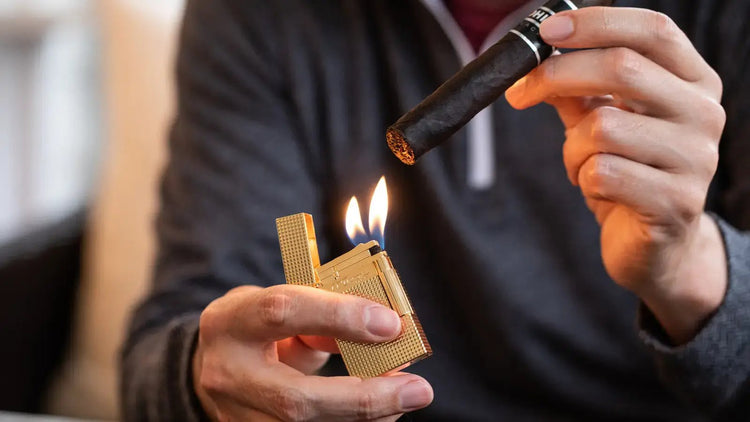 S.T. Dupont Gold Diamond head cigar lighter with double soft flame being used to ignite a cigar.