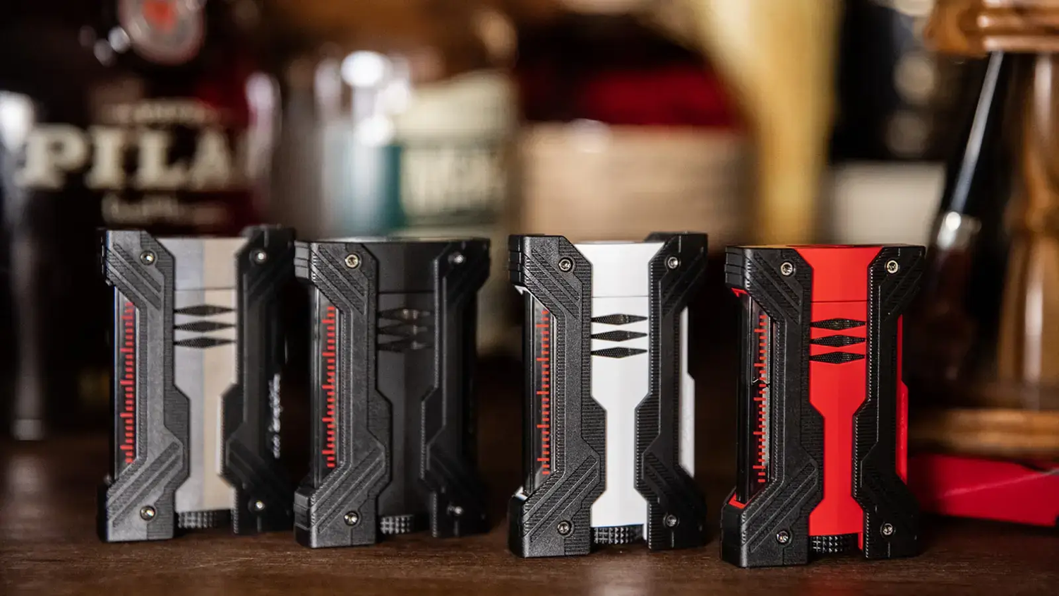 S.T. Dupont Defi XXtreme double flame torch lighters in chrome,, matte black, white and red with black accents.