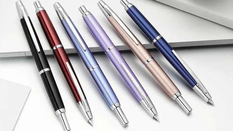 Pilot vanishing point decimo retractable fountain pens with rhodium trim. Shown in black, red, sky blue, purple, beige and dark blue