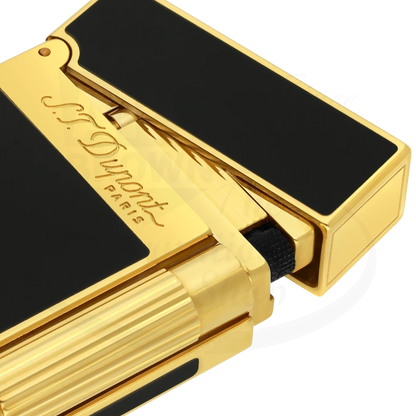 Corner of S.T. Dupont ligne 2 lighter with shiny black lacquer and gold accents.