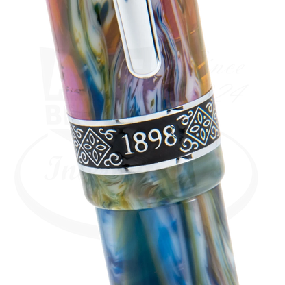 Close-up view of the Conklin 1898 Misto Green Rollerball Pen, showcasing its intricate multicolored marbled design and the engraved '1898' on the silver band.