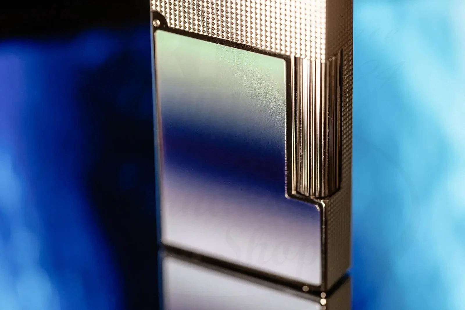 Isolated image of the S.T. Dupont Ligne 2 Perfect Ping La Mer Blue Lacquer & Palladium Lighter, closed and standing upright.