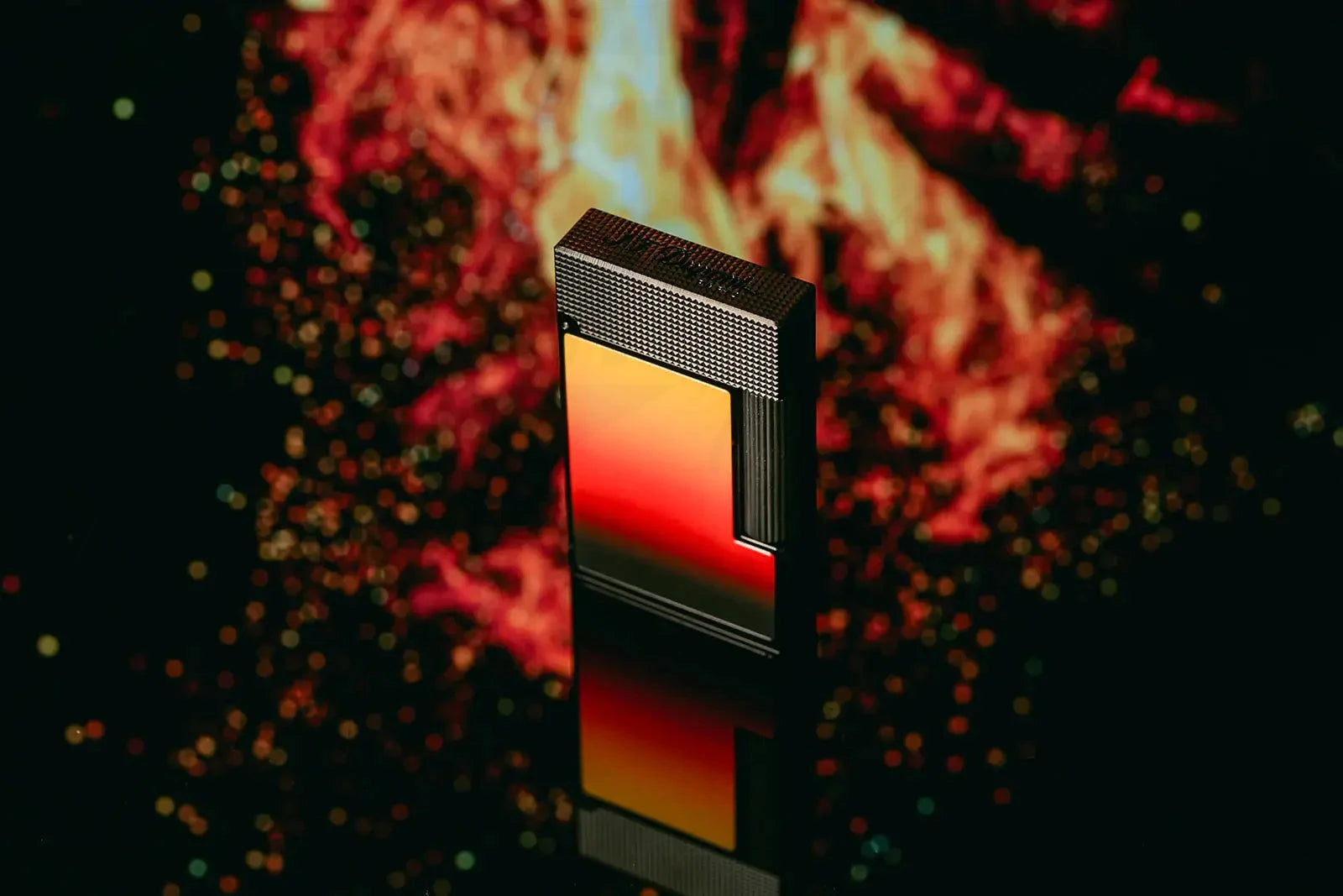 S.T. Dupont Line 2 La Flamme lighter showcasing red and orange gradient lacquer on a flaming background.