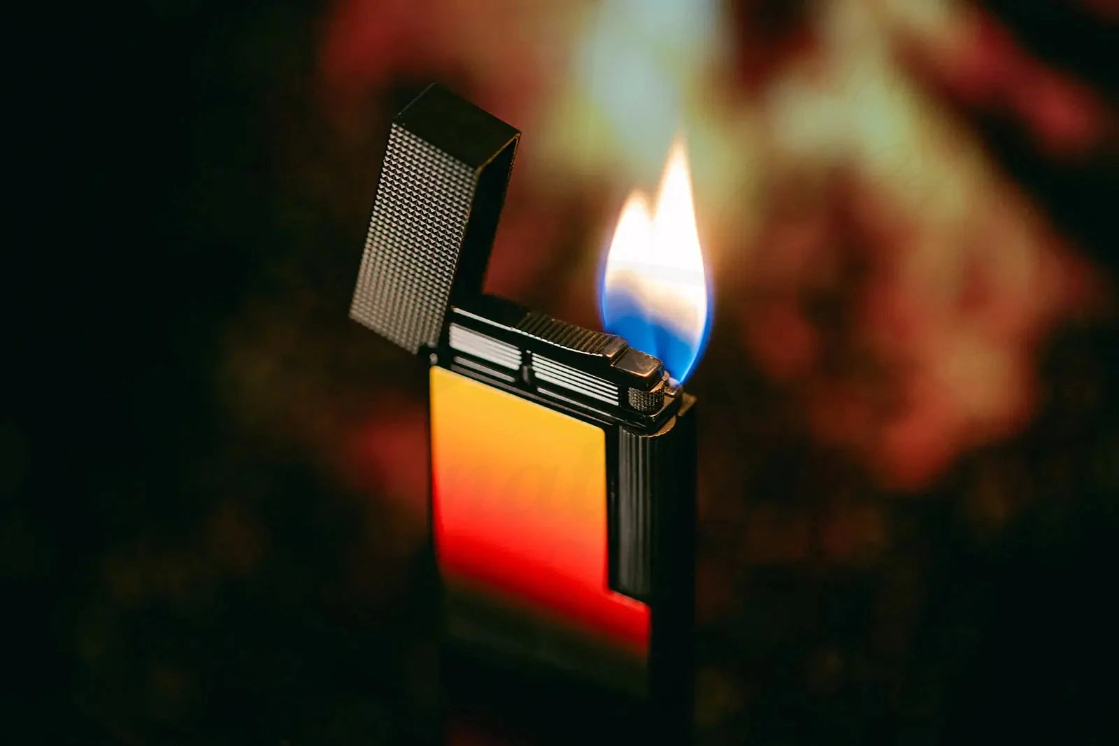 S.T. Dupont Line 2 La Flamme lighter showcasing red and orange gradient lacquer seen with dual flames ignited.