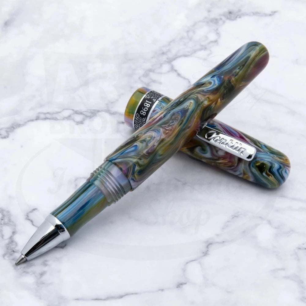 Conklin 1898 Misto Green Rollerball Pen shown open on a white marble surface, highlighting its vivid marbled pattern and polished silver details.