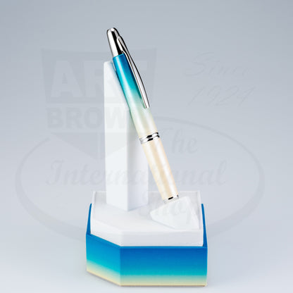 Pilot Vanishing Point Seashore 2024 Limited Edition fountain pen elegantly displayed in a matching blue ombre pen stand.